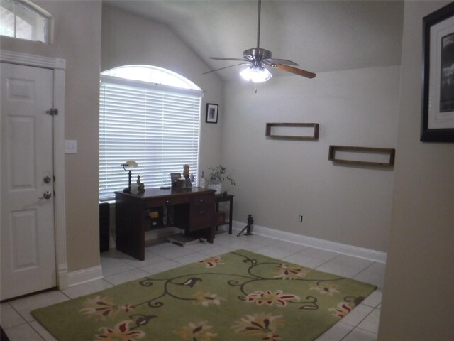 entrance foyer with baseboards, light tile patterned floors, ceiling fan, and vaulted ceiling