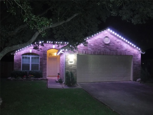 1409 Barras St, Alvin, TX 77511 - view of front of house featuring driveway, an attached garage, stone siding, and a lawn