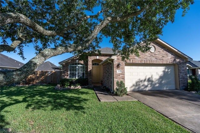 1409 Barras St, Alvin, TX 77511 - ranch-style home featuring a garage, driveway, and brick siding