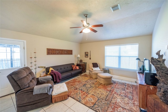 1409 Barras St, Alvin, TX 77511 - living room with a ceiling fan, light tile patterned flooring, healthy amount of natural light, vaulted ceiling, and baseboards