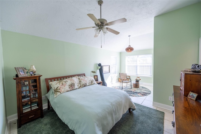 1409 Barras St, Alvin, TX 77511 - bedroom with tile patterned floors, a textured ceiling, ceiling fan, and baseboards