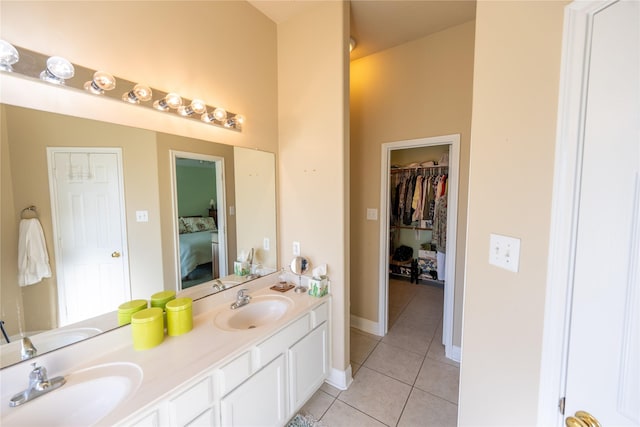 1409 Barras St, Alvin, TX 77511 - ensuite bathroom featuring tile patterned floors, double vanity, a spacious closet, and baseboards