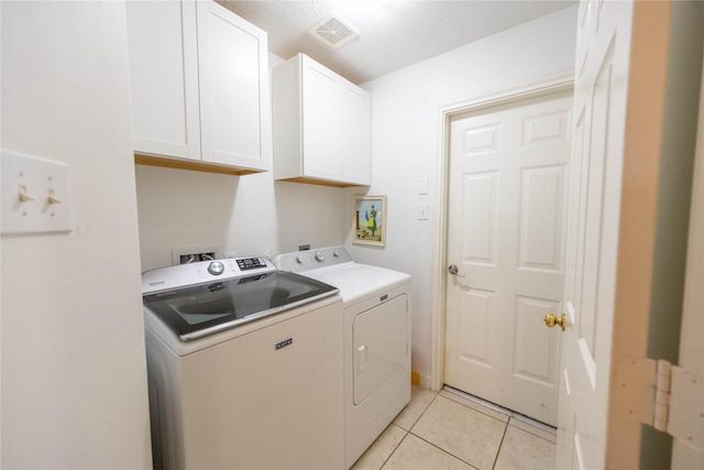 1409 Barras St, Alvin, TX 77511 - laundry area featuring cabinet space, washer and dryer, and light tile patterned floors