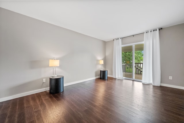 empty room with wood finished floors and baseboards