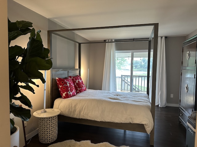 bedroom with access to exterior, wood finished floors, and baseboards