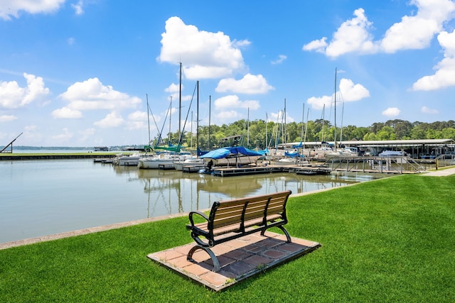 dock area featuring a lawn and a water view