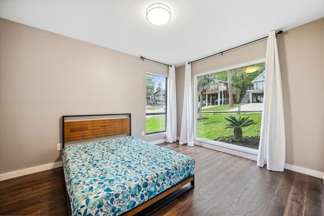 bedroom featuring wood finished floors and baseboards