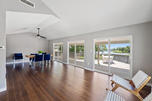 living room with ceiling fan, wood finished floors, visible vents, baseboards, and lofted ceiling