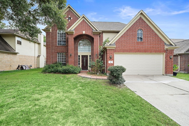 traditional-style home featuring concrete driveway, a front lawn, an attached garage, and brick siding