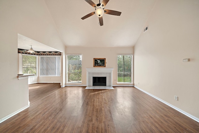 unfurnished living room featuring a tile fireplace, a wealth of natural light, visible vents, a ceiling fan, and high vaulted ceiling