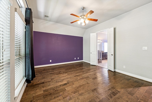 unfurnished bedroom with lofted ceiling, wood finished floors, visible vents, and baseboards