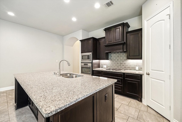 kitchen with light tile patterned floors, a sink, appliances with stainless steel finishes, and visible vents