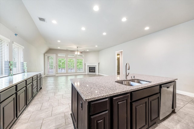 kitchen with a sink, a ceiling fan, visible vents, stainless steel dishwasher, and an island with sink