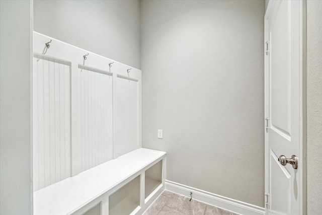 mudroom with tile patterned flooring and baseboards