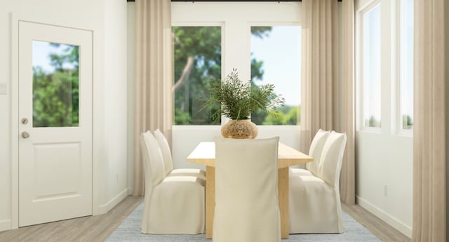 dining area with light wood-style floors and baseboards