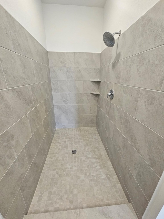 full bath featuring a tile shower