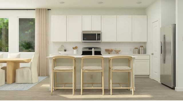 kitchen featuring white cabinetry, tasteful backsplash, and appliances with stainless steel finishes