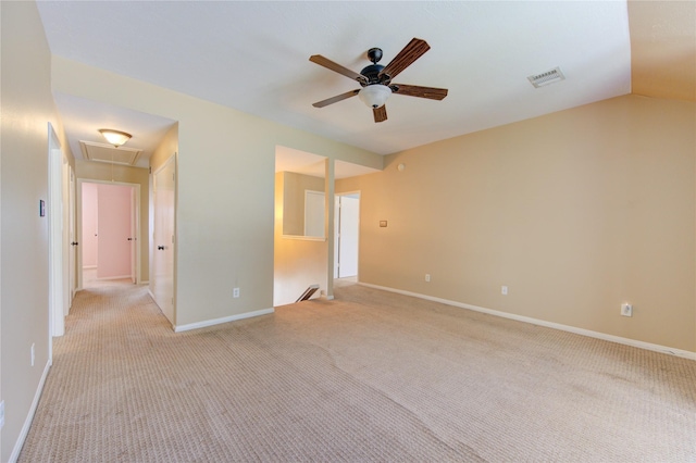 unfurnished room featuring visible vents, attic access, ceiling fan, and light carpet