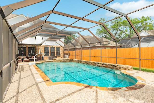 pool featuring fence, a patio area, an in ground hot tub, and glass enclosure