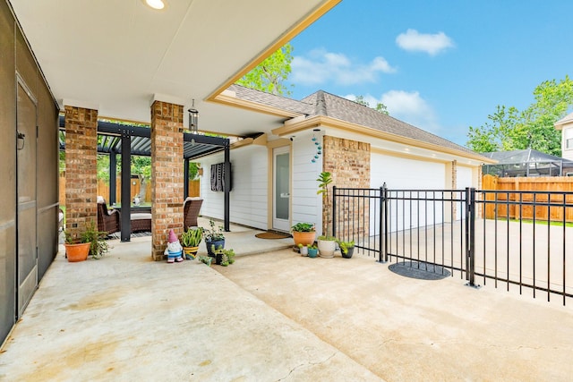 view of patio featuring a garage and a fenced backyard