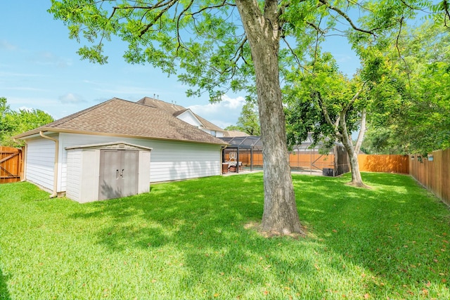 view of yard featuring a fenced backyard, an outbuilding, and a storage shed