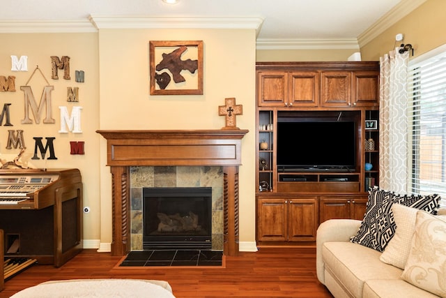 living area featuring baseboards, ornamental molding, a fireplace, and dark wood-type flooring