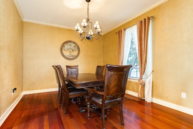 dining space featuring crown molding, wood finished floors, a chandelier, and baseboards