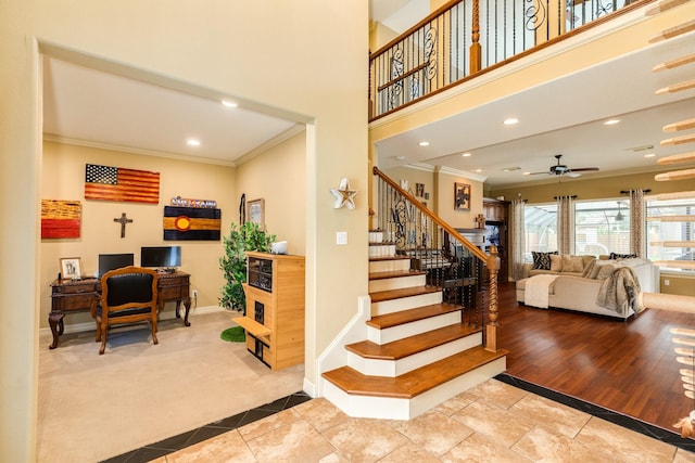 stairs with recessed lighting, carpet, baseboards, a ceiling fan, and crown molding