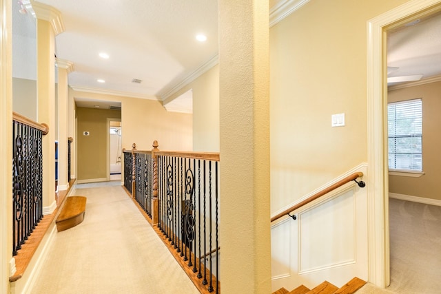 hallway with crown molding, an upstairs landing, carpet flooring, and baseboards