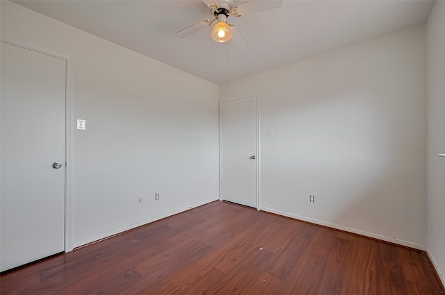 unfurnished room with baseboards, wood finished floors, and ceiling fan