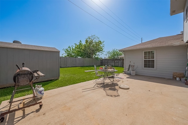 view of patio featuring an outdoor structure and a fenced backyard