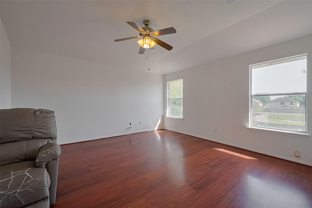 empty room featuring ceiling fan, wood finished floors, and baseboards