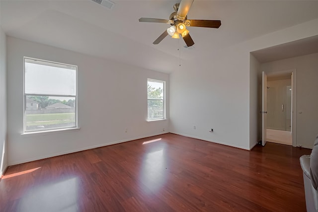 empty room featuring wood finished floors, visible vents, ceiling fan, and baseboards