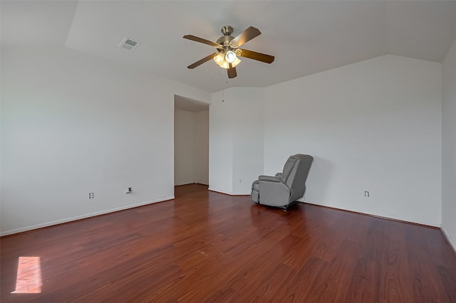 unfurnished room featuring visible vents, a ceiling fan, dark wood-style flooring, and vaulted ceiling
