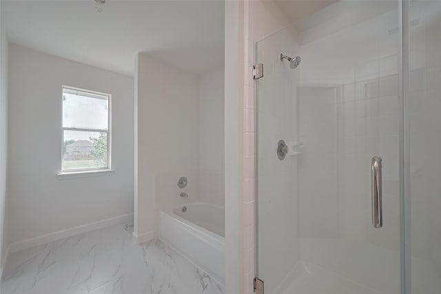 bathroom with baseboards, a shower stall, a bath, and marble finish floor