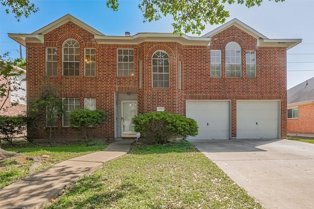 view of front of home with a front yard, concrete driveway, brick siding, and an attached garage