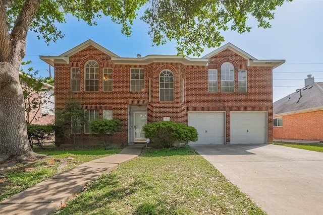 view of front facade with a front yard, driveway, a garage, and brick siding