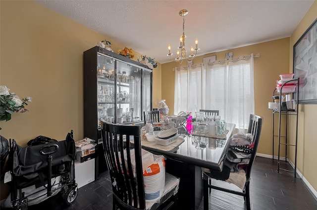 dining area with a healthy amount of sunlight, baseboards, an inviting chandelier, and dark wood-style flooring