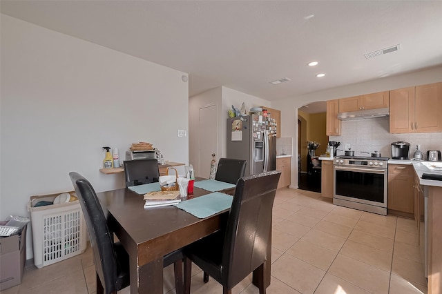 dining space featuring visible vents, light tile patterned floors, arched walkways, and recessed lighting