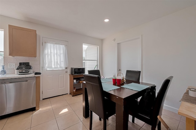 dining space featuring light tile patterned floors and recessed lighting