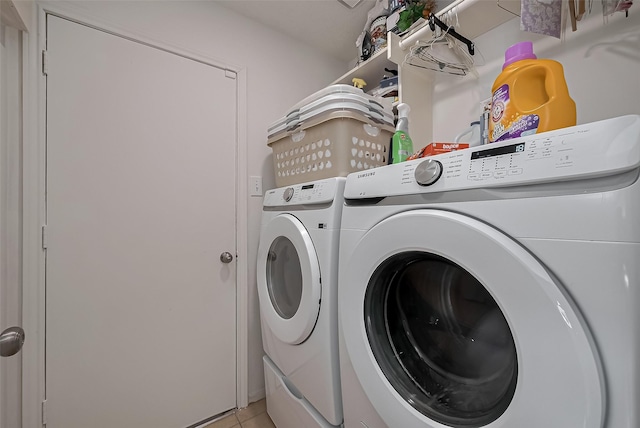 laundry area featuring light tile patterned floors, independent washer and dryer, and laundry area