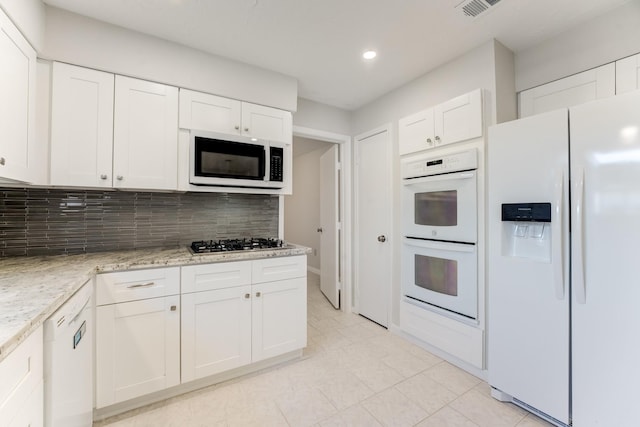 kitchen with tasteful backsplash, white cabinetry, white appliances, and recessed lighting