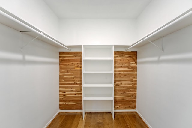 walk in closet featuring wood finished floors