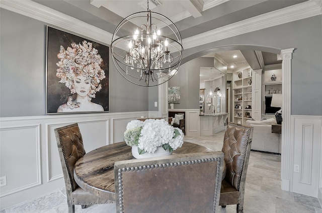 dining room featuring arched walkways, ornamental molding, and a decorative wall