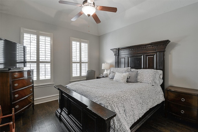 bedroom with baseboards, multiple windows, ceiling fan, and dark wood-type flooring