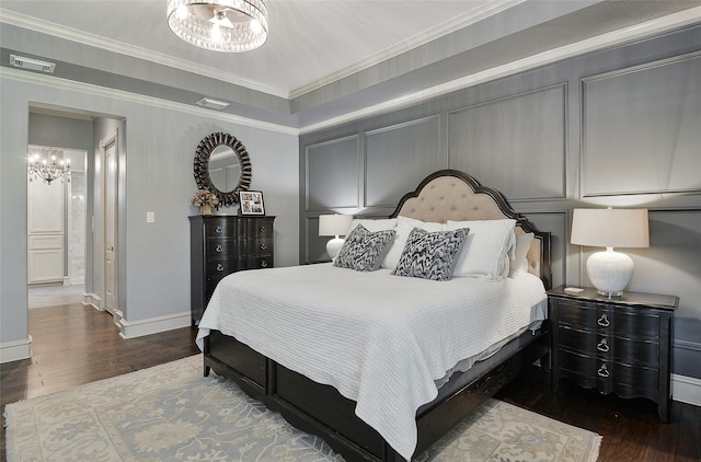 bedroom featuring an inviting chandelier, baseboards, wood finished floors, and visible vents