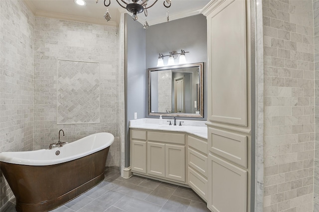 full bath featuring a freestanding tub, tile patterned flooring, ornamental molding, and vanity