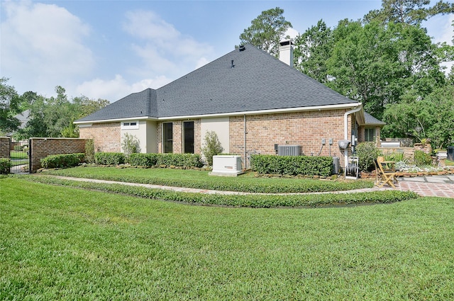 1330 Royal Sands Ln, Houston, TX 77345 - rear view of house with brick siding, a chimney, and a shingled roof