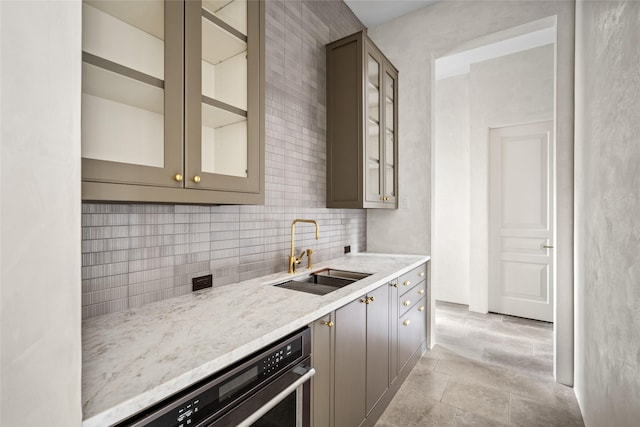 2525 Inwood Dr, Houston, TX 77019 - kitchen with light stone counters, tasteful backsplash, glass insert cabinets, dishwasher, and gray cabinets