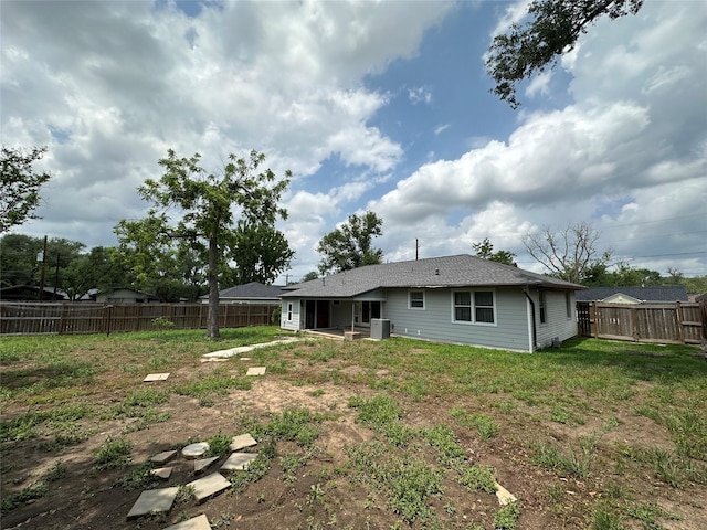 view of yard featuring central AC and a fenced backyard